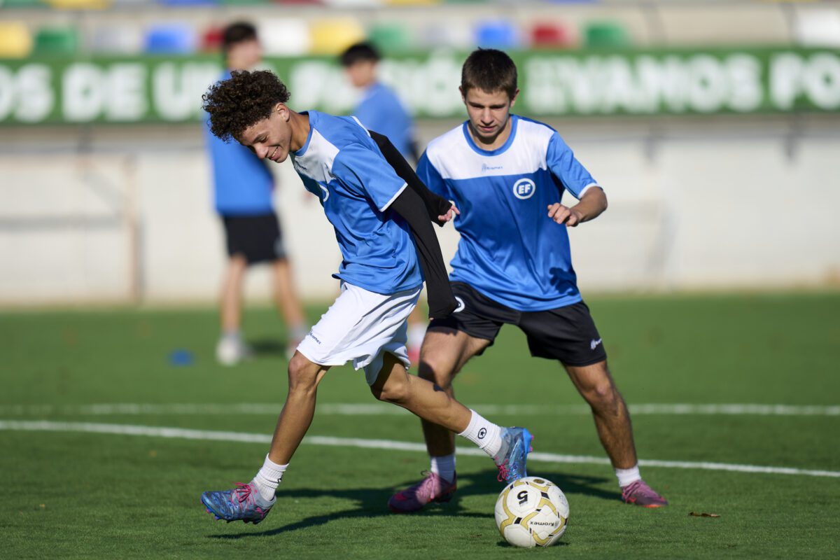 Dos jugadores disputando en el balón, durante un campus de fútbol organizado en Madrid por EliteFootball